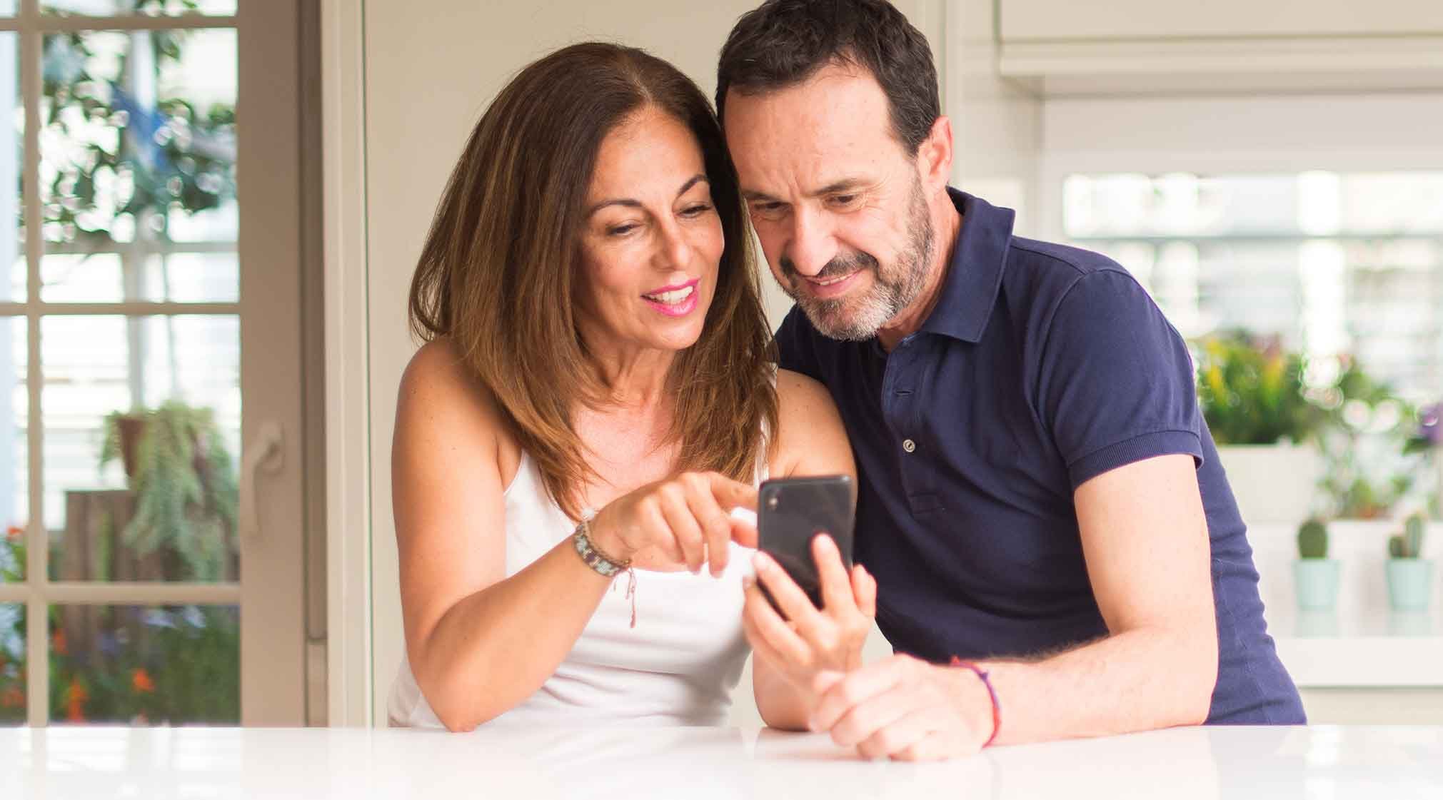 woman-and-man-on-smartphone-looking-at-google-business-profiles