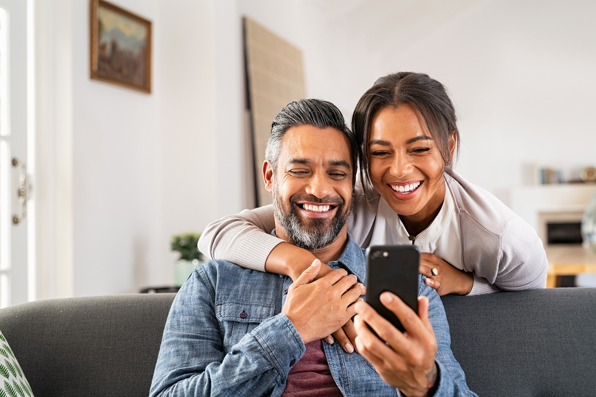 Couple smiling at phone